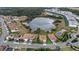 The aerial view captures a neighborhood with homes nestled around a serene lake, offering peaceful residential living at 1640 Oak Blossom Dr, Davenport, FL 33837