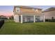 A spacious backyard features a screened lanai with comfortable seating, perfect for outdoor relaxation and entertaining at 1640 Oak Blossom Dr, Davenport, FL 33837
