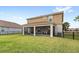 Expansive backyard featuring a screened lanai and lush green lawn, perfect for outdoor living and entertaining at 1640 Oak Blossom Dr, Davenport, FL 33837