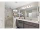 Bathroom featuring walk-in shower, double vanity, and neutral color palette at 1640 Oak Blossom Dr, Davenport, FL 33837