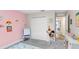Cozy bedroom with pink accent wall, closet, and a decorative rug at 1640 Oak Blossom Dr, Davenport, FL 33837