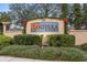 Elegant community entrance sign with lush landscaping and decorative details at 1640 Oak Blossom Dr, Davenport, FL 33837