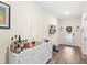The entryway features a white cabinet with gold accents, wood flooring, and a decorative wreath on the glass door at 1640 Oak Blossom Dr, Davenport, FL 33837