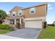 Well-maintained home featuring a brick-paved driveway and a two-car garage, complemented by manicured landscaping at 1640 Oak Blossom Dr, Davenport, FL 33837