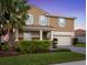 Attractive two-story home with lush landscaping and a spacious driveway at 1640 Oak Blossom Dr, Davenport, FL 33837