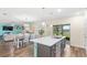 Open-concept layout seamlessly connects kitchen with island seating and dining area to views of the water at 1640 Oak Blossom Dr, Davenport, FL 33837