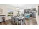 Charming eat-in kitchen boasts stainless appliances, wood floors, dining table and backyard views at 1640 Oak Blossom Dr, Davenport, FL 33837