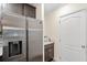 Kitchen area featuring stainless refrigerator and storage next to white door at 1640 Oak Blossom Dr, Davenport, FL 33837