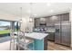 Bright kitchen with modern stainless appliances, island with seating, and views of the backyard at 1640 Oak Blossom Dr, Davenport, FL 33837
