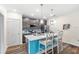 Modern kitchen featuring stainless appliances, subway tile backsplash, and two bar stools at center island at 1640 Oak Blossom Dr, Davenport, FL 33837
