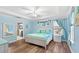 Light and bright main bedroom with tray ceiling, wood floors, and ensuite bathroom at 1640 Oak Blossom Dr, Davenport, FL 33837