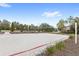 Sand volleyball court ready for a friendly game, surrounded by trees and a well-maintained landscape at 1640 Oak Blossom Dr, Davenport, FL 33837