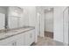 Modern bathroom with double sinks, granite countertops, white cabinets, and a glass-enclosed shower at 2089 Rosewood Dr, Bartow, FL 33830