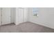 Bright bedroom with a window, large closet, and neutral carpeting at 2089 Rosewood Dr, Bartow, FL 33830