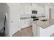 Modern kitchen with granite countertops, stainless steel appliances, and white shaker cabinets at 2089 Rosewood Dr, Bartow, FL 33830