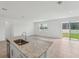 Spacious kitchen island with granite countertop, stainless steel sink, and seating area at 2089 Rosewood Dr, Bartow, FL 33830