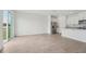 Open-concept living room with tile flooring, stainless steel fridge, and sliding glass doors to the backyard at 2089 Rosewood Dr, Bartow, FL 33830