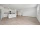 Open-plan living space featuring tile floors, white walls, recessed lights, and a kitchen with modern appliances at 2089 Rosewood Dr, Bartow, FL 33830