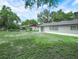 Expansive backyard featuring lush greenery and a charming patio area perfect for outdoor gatherings at 228 Kilmer Ln, Winter Haven, FL 33884