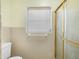 Bathroom featuring tiled walls, a toilet, and shower with bright white tile at 228 Kilmer Ln, Winter Haven, FL 33884