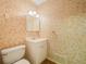 Bathroom with single sink vanity, cabinet lighting, and patterned wallpaper at 228 Kilmer Ln, Winter Haven, FL 33884