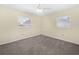 Bedroom with carpeted floor, neutral paint, ceiling fan and two windows at 228 Kilmer Ln, Winter Haven, FL 33884
