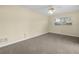 Bedroom with neutral carpet, white ceiling fan, and a large window at 228 Kilmer Ln, Winter Haven, FL 33884