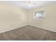 Bedroom with carpeted floor, neutral paint, ceiling fan and window at 228 Kilmer Ln, Winter Haven, FL 33884