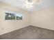 Bedroom with carpeted floor, neutral paint, ceiling fan and window at 228 Kilmer Ln, Winter Haven, FL 33884