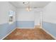 Dining room with tile flooring, light blue lower wall, and chandelier at 228 Kilmer Ln, Winter Haven, FL 33884