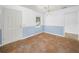 Dining room features a light blue accent wall, chandelier, and view to the kitchen at 228 Kilmer Ln, Winter Haven, FL 33884