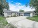 Well-maintained home featuring a two-car garage, new exterior paint, and meticulous landscaping at 228 Kilmer Ln, Winter Haven, FL 33884