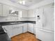 Bright kitchen featuring white cabinets, stainless steel appliances, and laminate countertops at 228 Kilmer Ln, Winter Haven, FL 33884