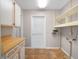 Laundry room with cabinets, tile floor, and access door at 228 Kilmer Ln, Winter Haven, FL 33884