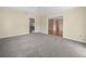 Spacious living room features neutral carpet and access to other rooms at 228 Kilmer Ln, Winter Haven, FL 33884