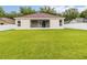 Expansive backyard has lush green grass, a white fence, and an enclosed lanai attached to the home at 2280 Yorville Ct, Ocoee, FL 34761