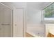 Bright bathroom features a soaking tub and a separate shower with glass door at 2280 Yorville Ct, Ocoee, FL 34761