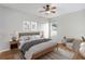 This staged main bedroom is a light and airy space with a ceiling fan and modern decor at 2280 Yorville Ct, Ocoee, FL 34761