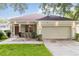 Charming single-story home with a well-manicured lawn and an attached two-car garage at 2280 Yorville Ct, Ocoee, FL 34761