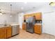 The kitchen offers stainless steel appliances and wood cabinets with a neutral backsplash at 2280 Yorville Ct, Ocoee, FL 34761