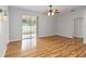 Sunlit living room with sliding glass door to a screened lanai and hardwood flooring at 2280 Yorville Ct, Ocoee, FL 34761