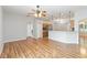 Living area with hardwood floors connects to a well-equipped kitchen with stainless appliances at 2280 Yorville Ct, Ocoee, FL 34761
