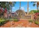 Allamanda Grace community sign with lush landscaping, palm trees, and colorful foliage at 2406 Placid Way, Kissimmee, FL 34758