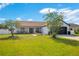 Beautifully landscaped front yard with mature trees and a well-maintained lawn, creating an inviting curb appeal at 2406 Placid Way, Kissimmee, FL 34758