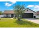 Charming single-story home featuring a well-manicured lawn and a two car garage at 2406 Placid Way, Kissimmee, FL 34758