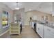 Bright eat-in kitchen features granite counters, stainless steel appliances, and light woodgrain tile floors at 2406 Placid Way, Kissimmee, FL 34758