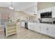 Bright eat-in kitchen features granite counters, stainless steel appliances, and light woodgrain tile floors at 2406 Placid Way, Kissimmee, FL 34758