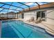 Sparkling screened-in pool area surrounded by lounging furniture, perfect for outdoor living at 2406 Placid Way, Kissimmee, FL 34758