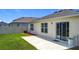 View of a backyard with green lawn, patio and sliding glass door at 2836 Sanctuary Dr, Clermont, FL 34714