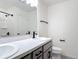 Modern bathroom with double vanity, dark hardware, and a shower-tub combo at 2836 Sanctuary Dr, Clermont, FL 34714